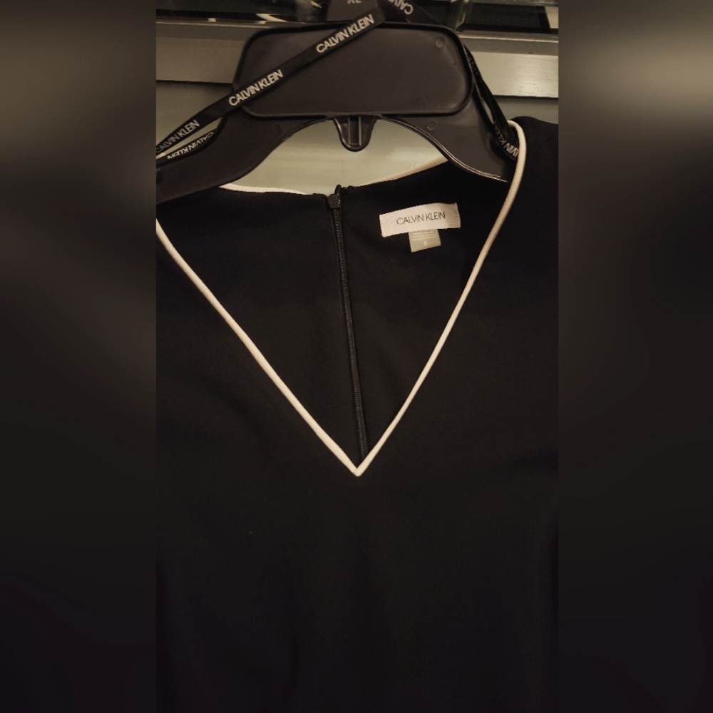 A black Calvin Klein dress with white linings
